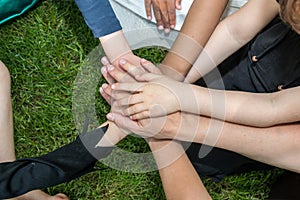 Hands of children on the lawn