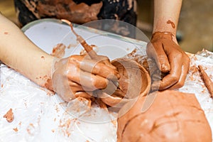 The hands of children learning pottery