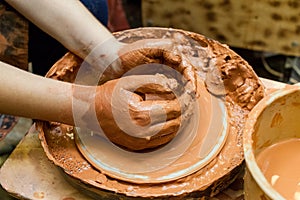 The hands of children learning pottery