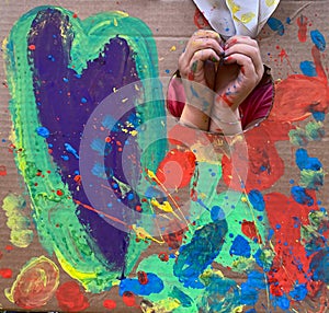 Hands of children painting on an art lab outdoor in the forest with colorful background, montessori school_freedom childhood right