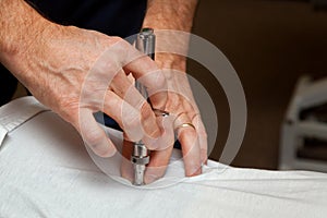 Hands of a Chiropractor Using an Integrator to Adjust the Spine photo