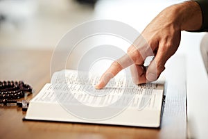 Hands, christian and bible book with rosary for praying, spiritual faith and holy worship of God in heaven. Closeup of