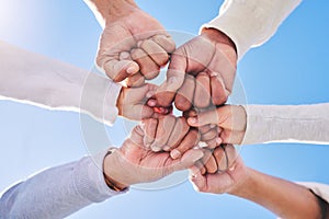 Hands in circle, blue sky and diversity for community in collaboration for global support and success. Teamwork, fist