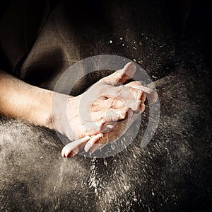 Hands clapping with flour