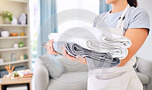 Hands, clean towels and woman with laundry, linen or cotton textile in stack at home. Spring cleaning, hygiene and