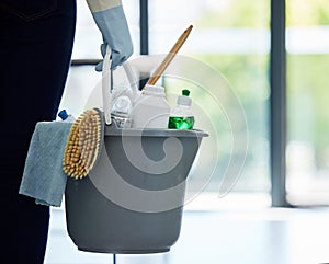 Hands, cleaner and bucket of supplies for cleaning, hygiene or disinfection at the office. Hand of person, housekeeper