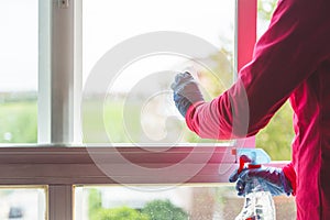 Hands cleaning dirty windowpanes. Home maintenance and cleaning concept