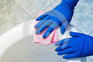 Hands cleaning toilet bowl. Toilet bactericidal treatment