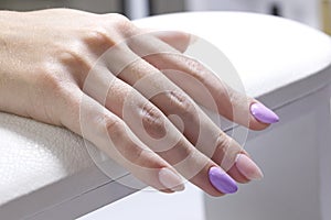 Hands of a client with colored gel coated nails closeup. photo