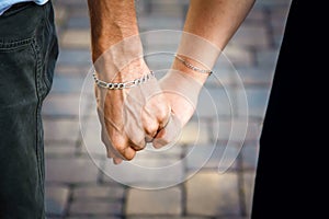 Hands closeup of a loving couple, romance, love, jeans. Concept idyll