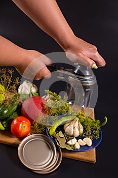 Hands closing jar with caning tool. Caning vegetables. Marinate vegetables