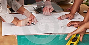 Hands, collaboration and architecture with a designer team planning on a table using a blueprint. Building, planning and