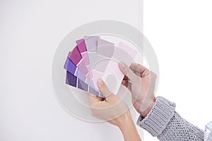 Hands, color swatches for interior design and paint choice, home renovation and person for development and plan. DIY