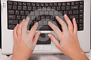 Hands on computer keyboard from top