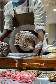 A hands of confectioner-chocolatier during at work. The making of cake