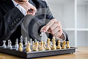 Hands of confident businessman playing chess game to development analysis new strategy plan, leader and teamwork concept for win