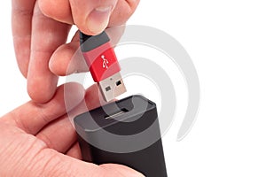 Hands connect the usb cable to the socket on a white background close-up. USB connection