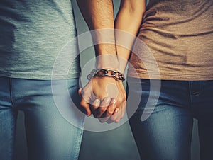 Hands connected by chain, symbolizing codependency
