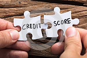 Hands Connecting Credit Score Jigsaw Pieces