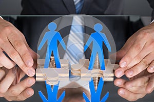 Hands connecting puzzle pices with people