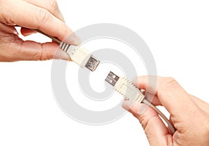 Hands connecting USB cables