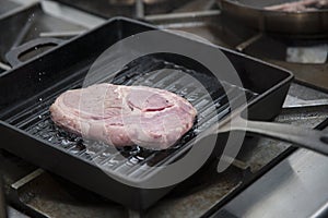 Hands cook cooking beef in a frying pan