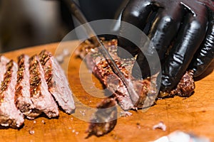 Hands cook cut fried meat