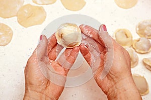 Hands of cook with dumplings