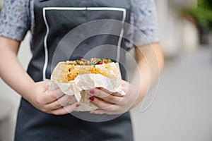 In the hands of the cook, falafel and fresh vegetables in pita b