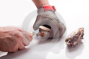 Hands of the cook opening an oyster