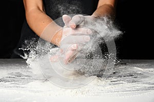 Hands of the cook splash clap with flour