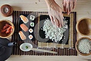 Hands cooking sushi