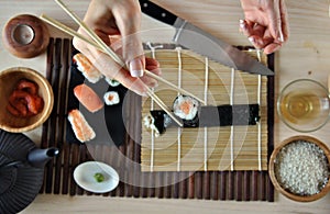 Hands cooking sushi