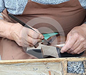 Hands of cordwainer in the workshop photo