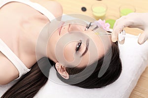 Hands of cosmetologist making injection in face. Young woman gets beauty facial injections in salon. Face aging, rejuvenation and