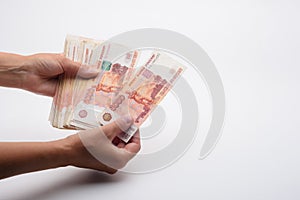 Hands count a five thousandth Russian banknotes