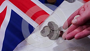 Hands counting loose change British money in coins