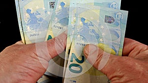 Hands counting stack cash twenty euro bills, recalculation banknotes.