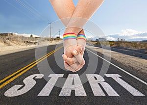 Hands of couple with gay pride rainbow wristbands