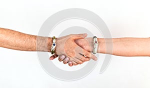 Hands of a couple of man and woman touching each other, wearing luxurious jade bracelets