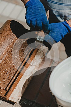 Put protective layer on tile with  brush