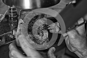 Hands of a craftsman jeweler working on jewelry. Goldsmith. Jewelry and valuables workshop. Goldsmith Hand Drill.