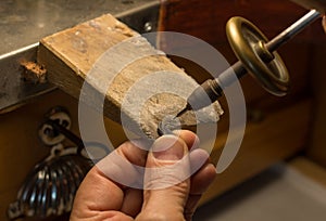 Hands of a craftsman jeweler working on jewelry. Goldsmith. Jewelry and valuables workshop. Goldsmith Hand Drill.