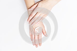 Hands with creame skin care, heart symbol on her hand