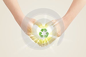 Hands creating a form with recycling sign