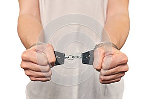 Hands of criminal in handcuffs, arrest of dangerous criminal, violation of law, white background