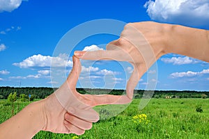 Hands cropping the rural landscape
