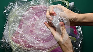 Hands crumple used plastic bags ready to recycling