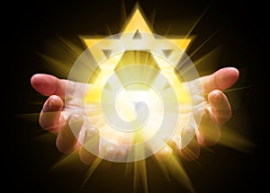 Hands cupped and holding or showing the Star of David. Magen David or Seal of Solomon photo