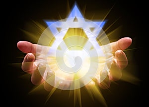 Hands cupped and holding or showing the Star of David. Magen David or Seal of Solomon photo